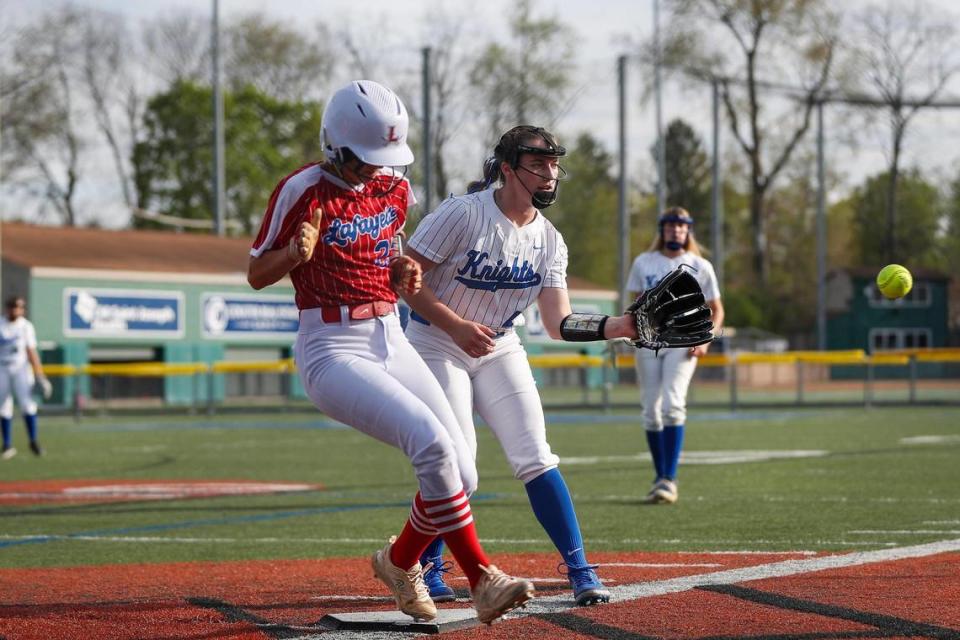 Lexington Catholic Abby Hammond (4) tries to tag out Lafayette’s Jenna Wells at home plate during their game at Lexington Catholic on April 13.