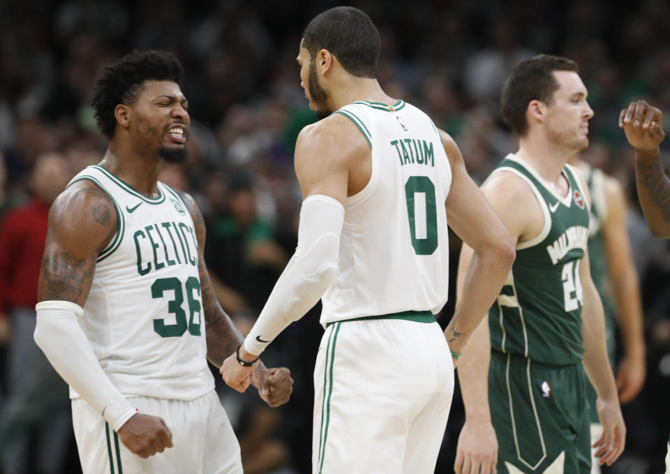 Celtics Marcus Smart and Jayson Tatum celebrate during a statement win over the Bucks. (Reuters)