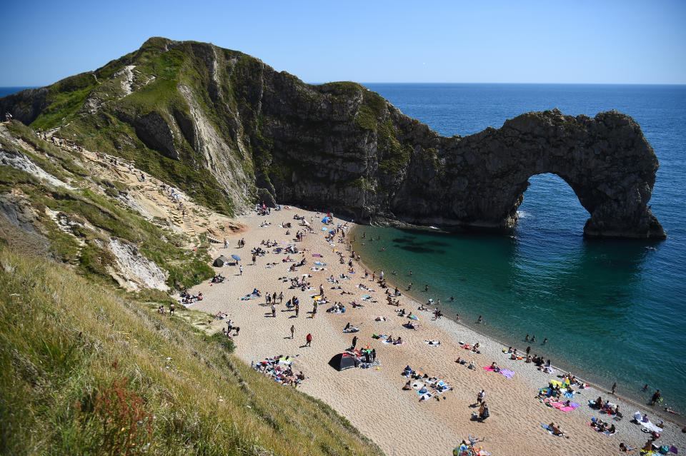 People enjoy the warm weather on the beach at Durdle Door, near Lulworth, in Dorset, after the public were reminded to practice social distancing following the relaxation of coronavirus lockdown restrictions in England. (Photo by Kirsty O'Connor/PA Images via Getty Images)