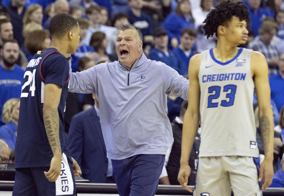 Creighton head coach Greg McDermott, center, yells for a timeout with 2.3 seconds remaining against UConn during the second half of an NCAA college basketball game on Saturday, Feb. 11, 2023, in Omaha, Neb. Creighton defeated UConn 56-53. (AP Photo/Rebecca S. Gratz)