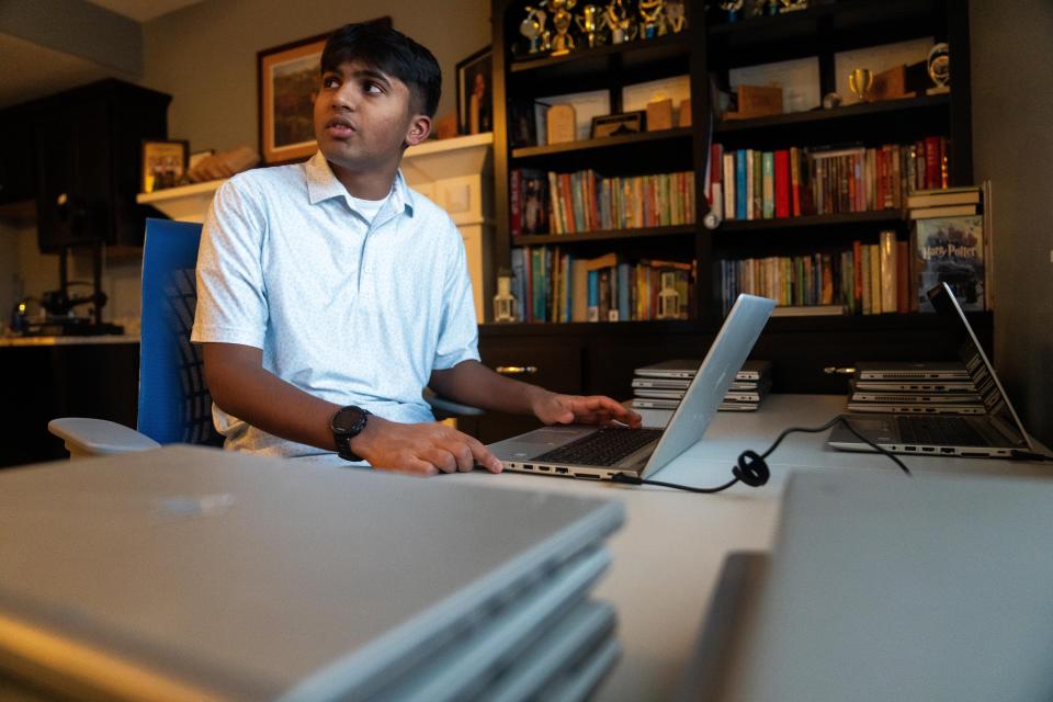 Kathir Kalyanaraman sits at his workspace in his Johnston home. The high school student is the founder of Tech Gift Foundation, which donates refurbished laptops and other personal electronics to refugees.