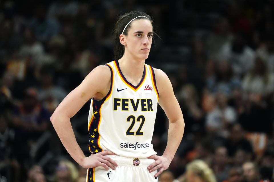 Indiana Fever guard Caitlin Clark pauses on the court during the first half of a WNBA basketball game against the Phoenix Mercury Sunday, June 30, 2024, in Phoenix. (AP Photo/Ross D. Franklin)