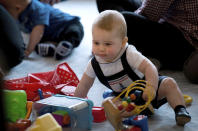 Britain's Prince George plays during a visit to Plunket nurse and parents group at Government House in Wellington, New Zealand, Wednesday, April 9, 2014. Plunket is a national not-for-profit organization that provides care for children and families in New Zealand. Britain's Prince William, his wife Kate, the Duchess of Cambridge and their son, Prince George, are on a three-week tour of New Zealand and Australia. (AP Photo/Marty Melville, Pool)