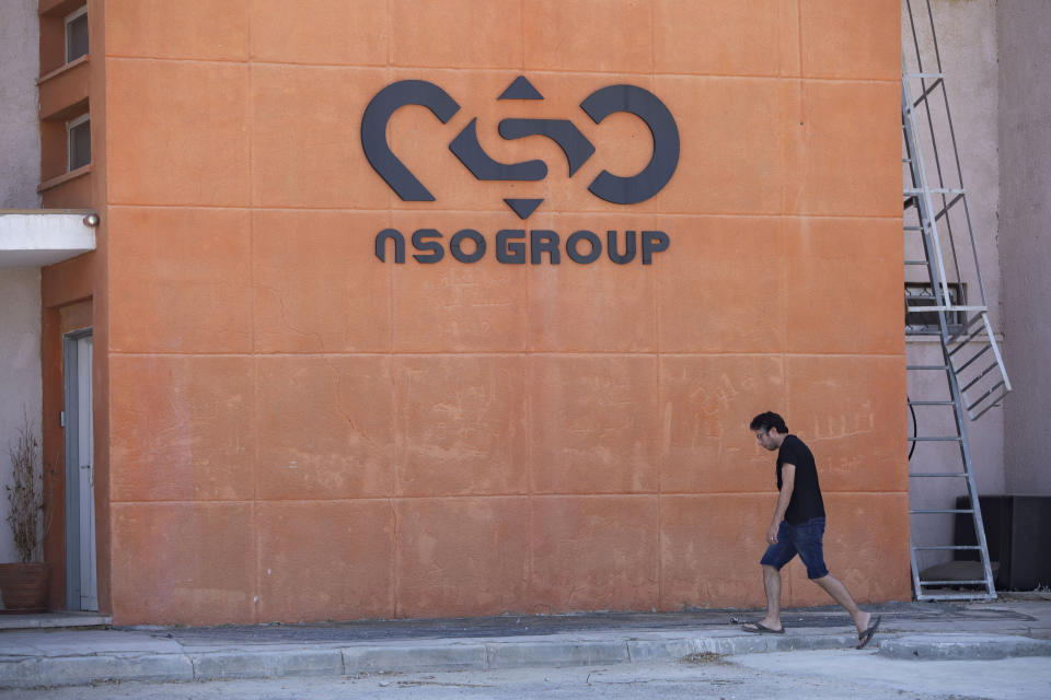 FILE - A logo adorns a wall at a branch of Israeli company NSO Group, near the southern Israeli town of Sapir, on Aug. 24, 2021. Tech giant Apple announced Tuesday, Nov. 23, that it will sue the Israel's NSO group, seeking to prevent the world's most infamous hacker-for-hire company from accessing Apple products, such as the iPhone.  (AP Photo/Sebastian Scheiner, File)