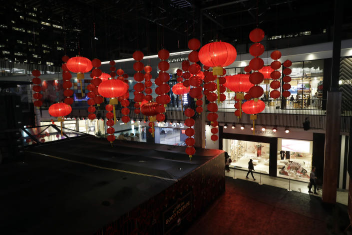 Decorations, part of a Lunar New Year installation, are placed in the main atrium of a mall Thursday, Jan. 31, 2019 in Santa Monica, Calif. In recent years, the Lunar or Chinese New Year, which people around the globe are ringing in Tuesday, seems to have achieved all-American status. Major companies are celebrating and capitalizing on a holiday that at its heart is about being with loved ones and wishing for prosperity and good luck. (AP Photo/Marcio Jose Sanchez)