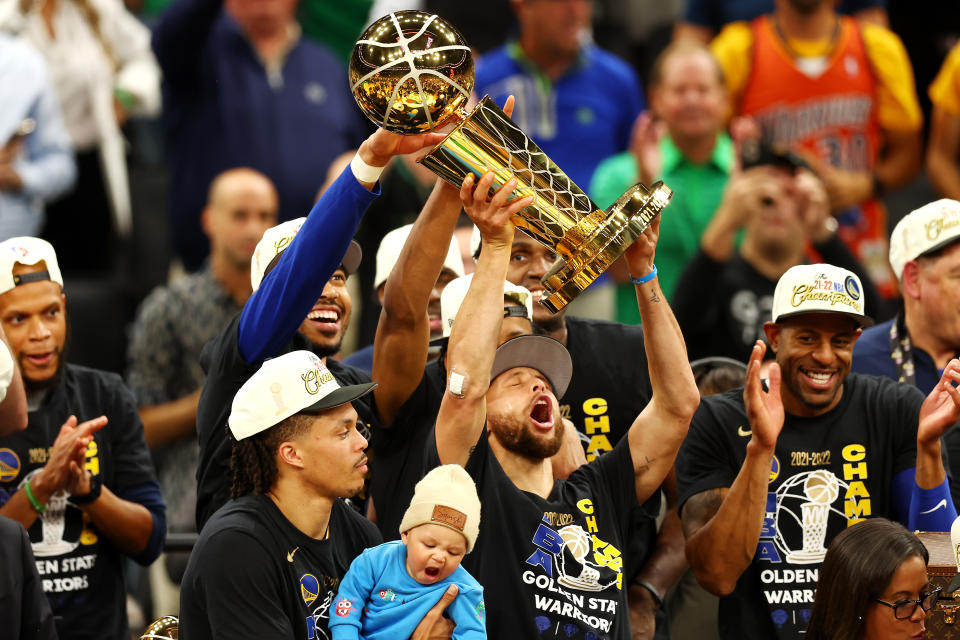 Stephen Curry and the Golden State Warriors raise the Larry O'Brien championship trophy after defeating the Boston Celtics in the 2022 NBA Finals on June 16, 2022. (Adam Glanzman/Getty Images)