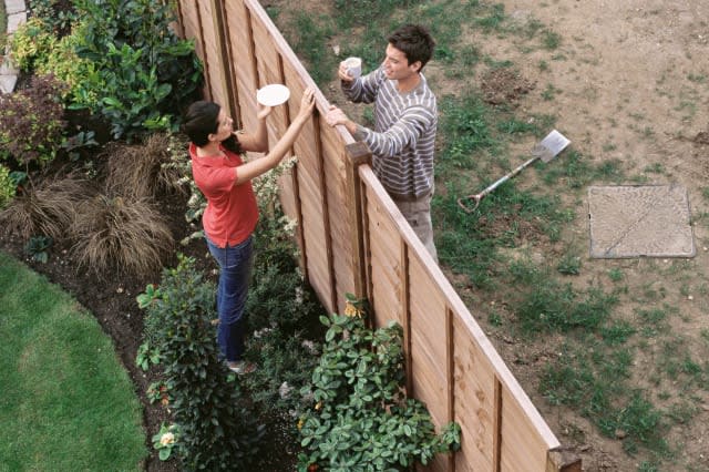 Neighbours having coffee over the fence