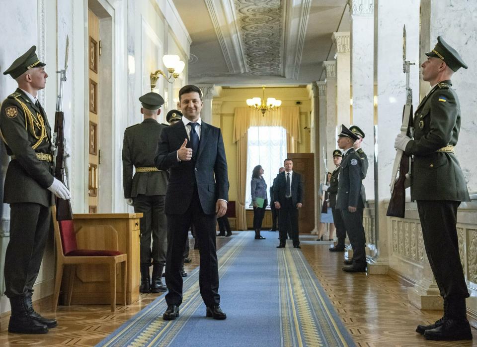 Ukrainian President-elect Volodymyr Zelenskiy, center, gestures as he waits to attend his inauguration ceremony in Kiev, Ukraine, Monday, May 20, 2019. Ukrainian TV star Volodymyr Zelenskiy has sought to capitalize on his huge popularity, dissolving the country's parliament Monday minutes after he was sworn in as president. (AP Photo/Zoya Shu, Pool)