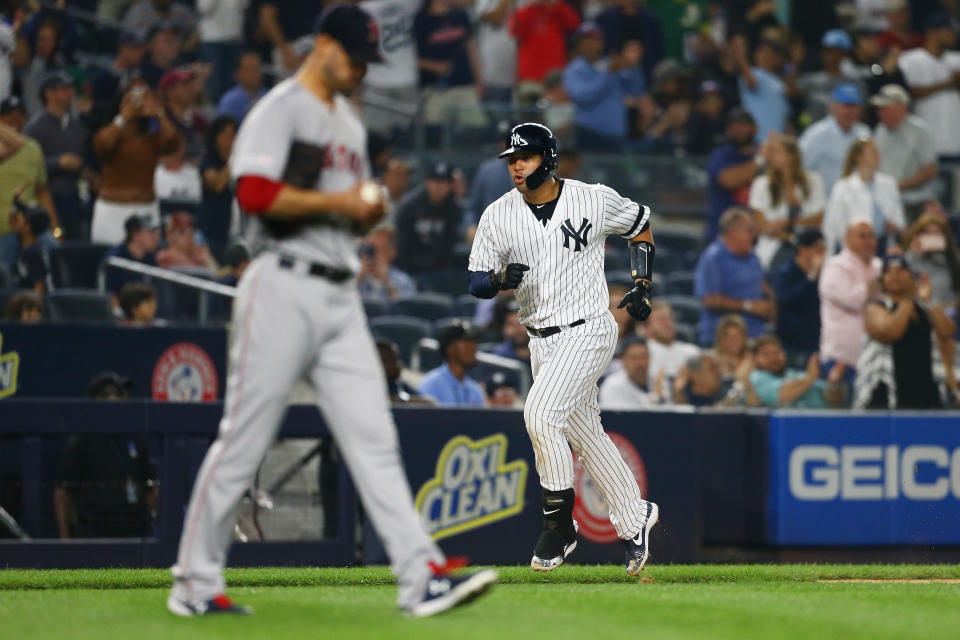 NEW YORK, NEW YORK - JUNE 01:  Gary Sanchez #24 of the New York Yankees rounds third base after hitting a two-run home run to center field during the fifth inning as Rick Porcello #22 of the Boston Red Sox looks on at Yankee Stadium on June 01, 2019 in New York City. (Photo by Mike Stobe/Getty Images)