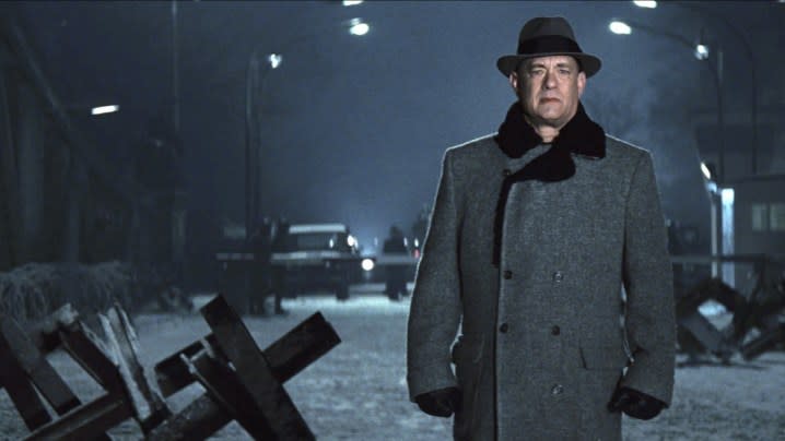 A man stands in a street in Bridge of Spies.