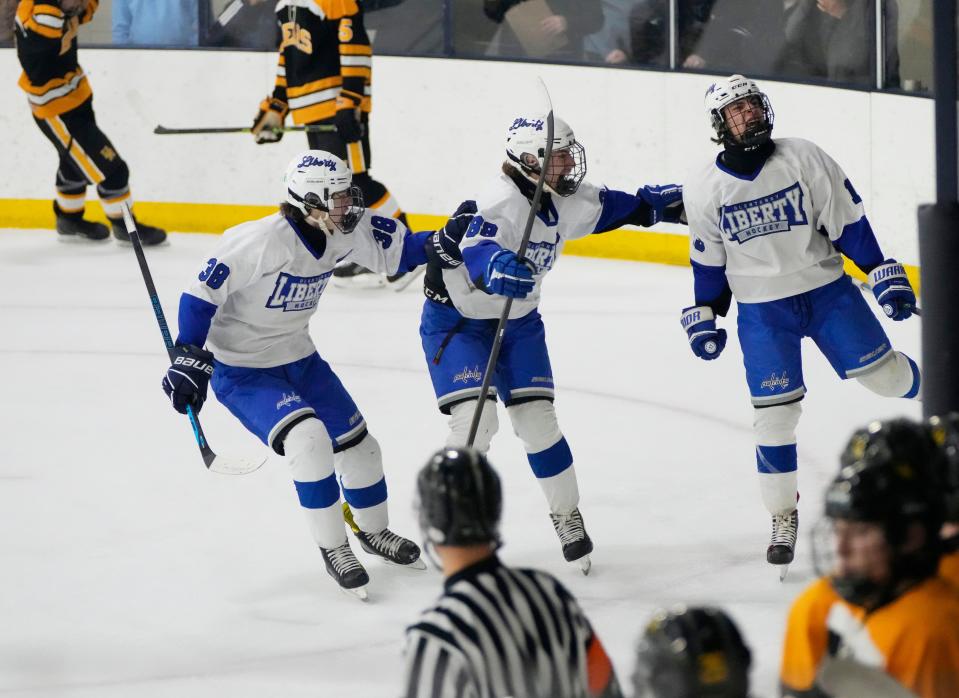 Olentangy Liberty's Eric Bauermeister, left, Brian Savage and Jake Bachus celebrate a goal during the district final win over Upper Arlington.