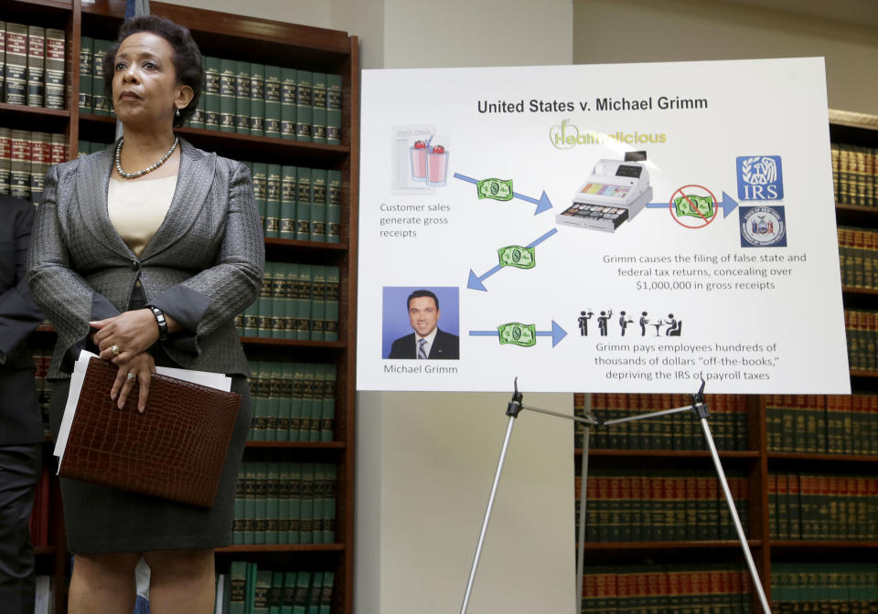 Loretta Lynch, U.S. Attorney for the Eastern District of New York, stands next to a poster displaying the alleged crimes committed by U.S. Rep. Michael Grimm during a news conference in New York, Monday, April 28, 2014. Lynch announced an indictment against Grimm, who was taken into custody Monday to face federal charges following a two-year investigation of his campaign financing. (AP Photo/Seth Wenig)