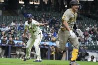 Milwaukee Brewers' Wade Miley flips the ball to first to get San Diego Padres' Ha-Seong Kim out on a bunt attempt during the third inning of a baseball game Tuesday, April 16, 2024, in Milwaukee. (AP Photo/Morry Gash)