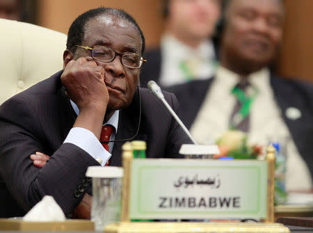 FILE PHOTO - Zimbabwe's President Robert Mugabe sleeps during the speech of Libya's then-leader Muammar Gaddafi at the start of the third European Union-Africa summit in Tripoli, Libya November 29, 2010. REUTERS/Francois Lenoir/File Photo