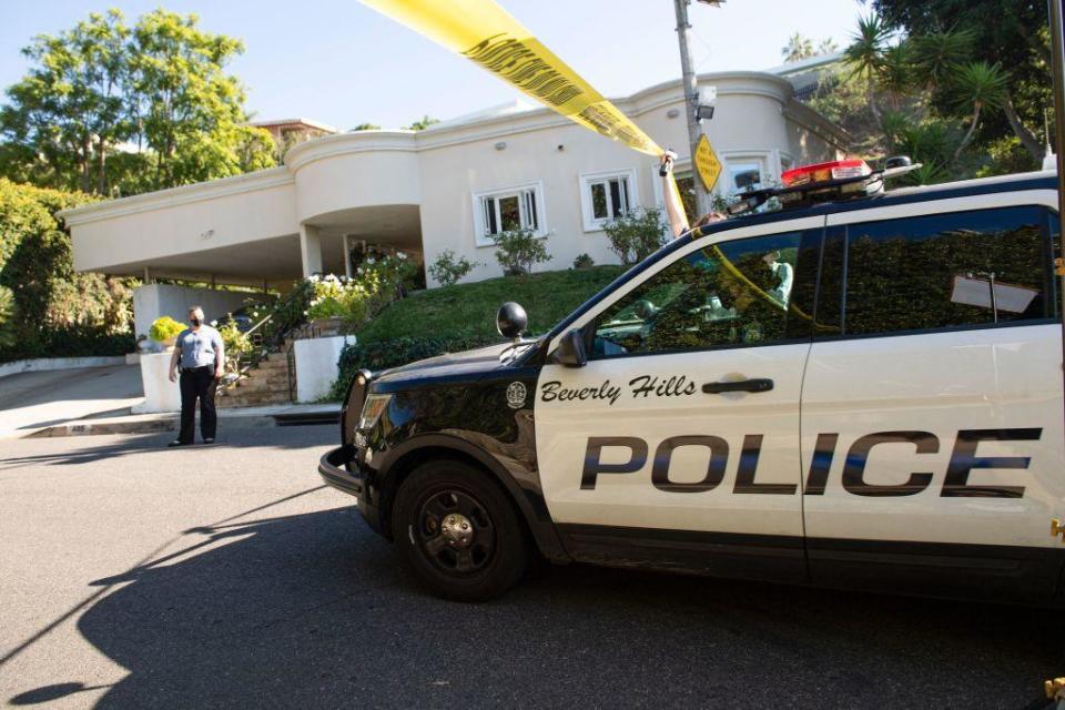 Police tape blocks access to the street where Jacqueline Avant was shot and killed in her house at the top of the hill, in Beverly Hills, California, on December 1, 2021.  / Credit: Valerie Macon/AFP via Getty Images