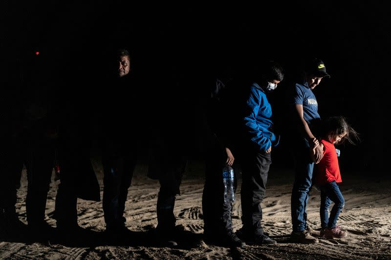 FILE PHOTO: Asylum-seeking migrants cross the Rio Grande river in Roma