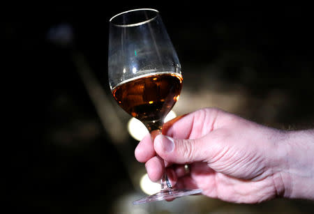 Zoltan Kovacs, general manager of the Royal Tokaji Wine Company shows a glass of Royal Tokaji Essencia in Mad, Hungary, April 12, 2019. Picture taken April 12, 2019. REUTERS/Bernadett Szabo