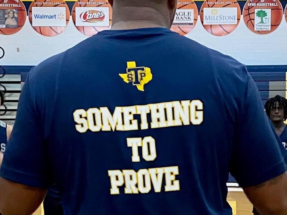 Stony Point coach Antoine Thompson wears his team's 2022-23 motto on his back. At 31, this is his first year as a high school head coach. He previously was an assistant at LBJ for five years.