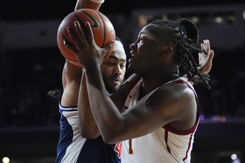 Southern California guard Isaiah Collier, right, is defended by Arizona guard Kylan Boswell during the first half of an NCAA college basketball game Saturday, March 9, 2024, in Los Angeles. (AP Photo/Marcio Jose Sanchez)