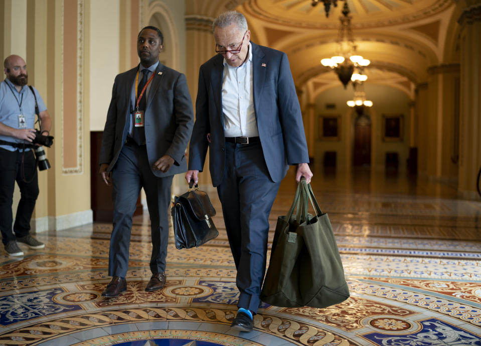 Senate Majority Leader Chuck Schumer, D-N.Y., carries his baggage as he arrives at the Capitol in Washington, Monday, June 7, 2021, after a ten-day recess. As Democrats strain to deliver on President Joe Biden's agenda, Schumer has warned colleagues that June will "test our resolve," as they return Monday to consider infrastructure, voting rights and other difficult priorities for his party. (AP Photo/J. Scott Applewhite)