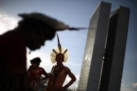 Pataxo Indians living in Bahia, in northeastern Brazil, stand near the Esplanade of Ministries in Brasilia March 12, 2014. The Indians are in Brasilia for meetings with authorities to discuss health needs and conflict issues between Indians and farmers including land ownership rights. REUTERS/Ueslei Marcelino (BRAZIL - Tags: POLITICS HEALTH CIVIL UNREST TPX IMAGES OF THE DAY)