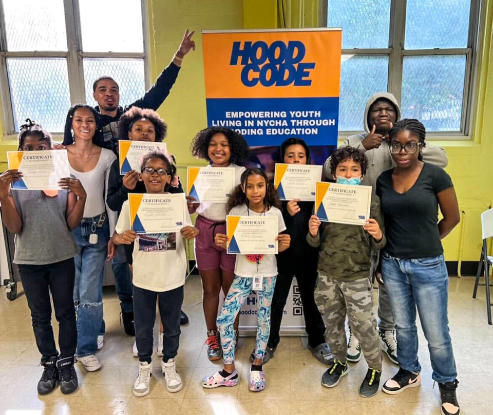 Jason Gibson, back left, stands with Hood Code students as they receive their participation certificate. (Courtesy Jason Gibson)