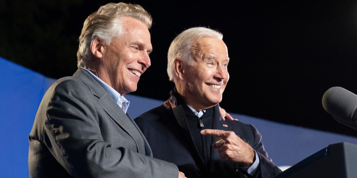 President Joe Biden, right, reacts after speaking at a rally for Democratic gubernatorial candidate, former Virginia Gov. Terry McAuliffe, Tuesday, Oct. 26, 2021, in Arlington, Va. McAuliffe will face Republican Glenn Youngkin in the November election.