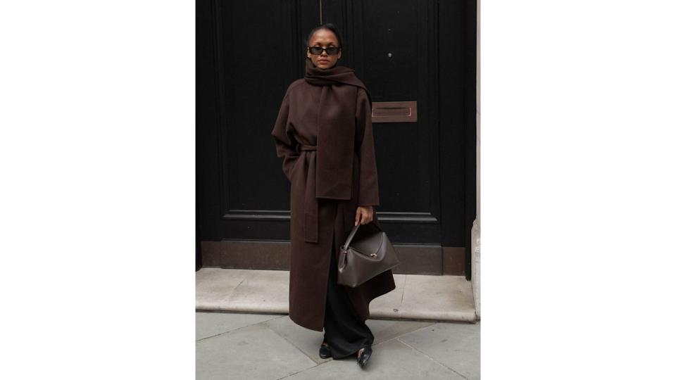 model with brown coat and bag