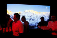 Waiters walk past LeEco's uMax85, an 85 inch television, during a press event in San Francisco, California, U.S. October 19, 2016. RETUERS/Beck Diefenbach