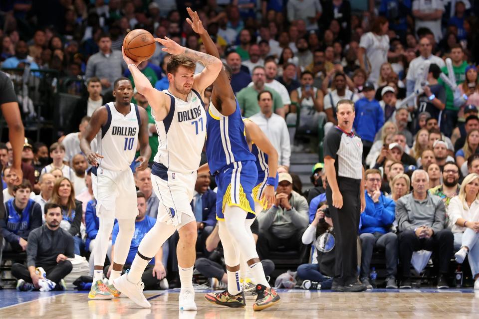 West finals: Mavericks guard Luka Doncic (77) looks to pass around Warriors defender Draymond Green (23) during the second half of Game 4.