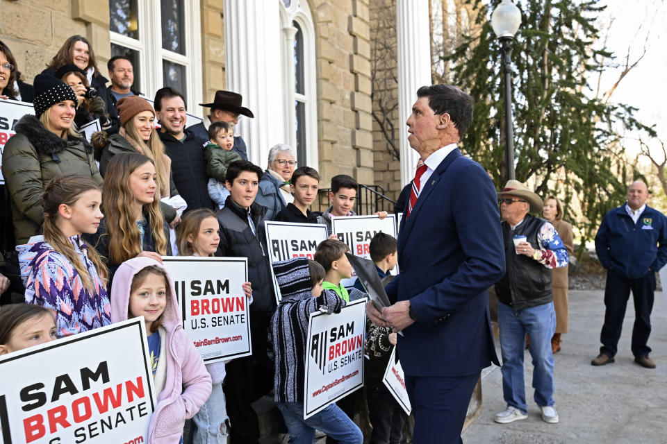 Republican U.S. Senatorial candidate Sam Brown talks with supporters after filing his paperwork to run for the Senate, Thursday, March 14, 2024, at the State Capitol in Carson City, Nev. Brown is seeking to replace incumbent U.S. Sen. Jacky Rosen. (AP Photo/Andy Barron)