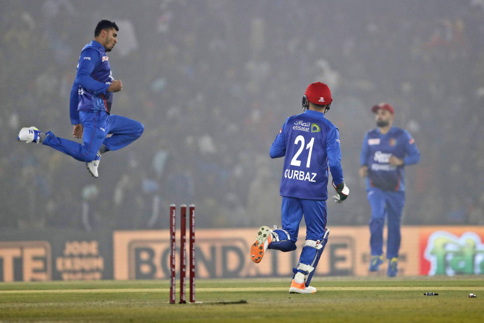 Mujeeb Ur Rahman, left, and Rahmanullah Gurbaz of Afghanistan celebrate the wicket of Shubman Gill of India during the first T20 cricket match between India and Afghanistan in Mohali, India, Thursday, Jan. 11, 2024. (AP Photo/Surjeet Yadav)
