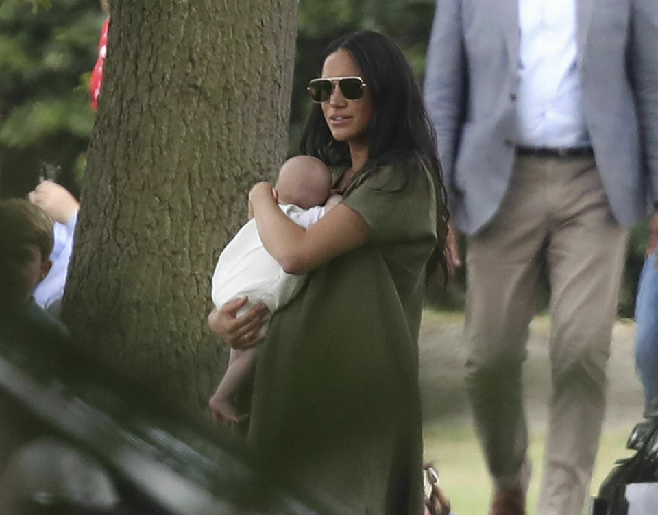Britain's Meghan, Duchess of Sussex holding her son Archie, at the Royal Charity Polo Day at Billingbear Polo Club, Wokingham, England, Wednesday, July 10, 2019. (Andrew Matthews/PA via AP)