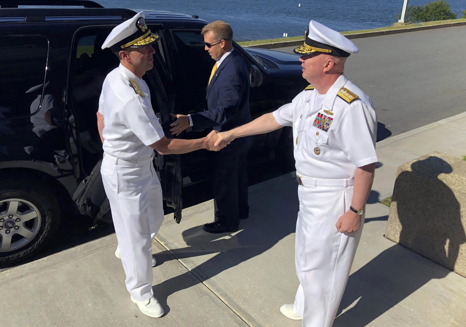 FILE - In this June 12, 2018, file photo, Adm. John Richardson, left, chief of naval operations, greets Rear Adm. Jeffrey Harley, president of the U.S. Naval War College in Newport, R.I. Dozens of emails, which span from December 2017 to May 2019, were shared with The Associated Press by people at the war college who said they were concerned about Rear Adm. Harley's leadership and judgment. (AP Photo/Jennifer McDermott, File)