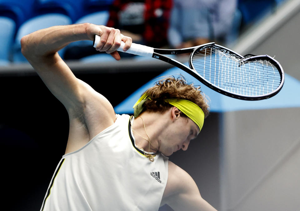 Germany's Alexander Zverev smashes his racket in frustration during his first round match against United States' Marcos Giron at the Australian Open tennis championship in Melbourne, Australia, Monday, Feb. 8, 2021.(AP Photo/Rick Rycroft)