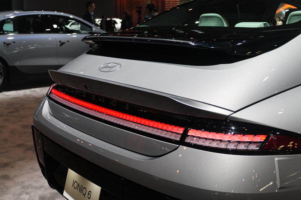 A red strip of brake light across the rear of the Hyundai Ioniq 6 sedan is shown up close