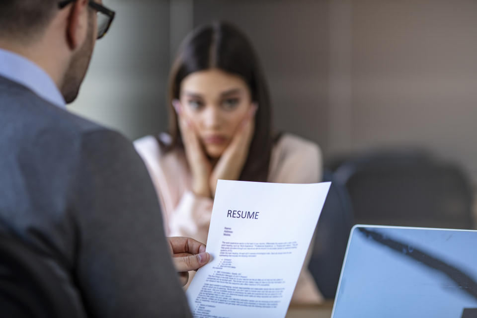 Nervous young job applicant wait for recruiters question during interview in office, worried intern or trainee feel stressed applying for open position, meeting with hr managers. Hiring concept