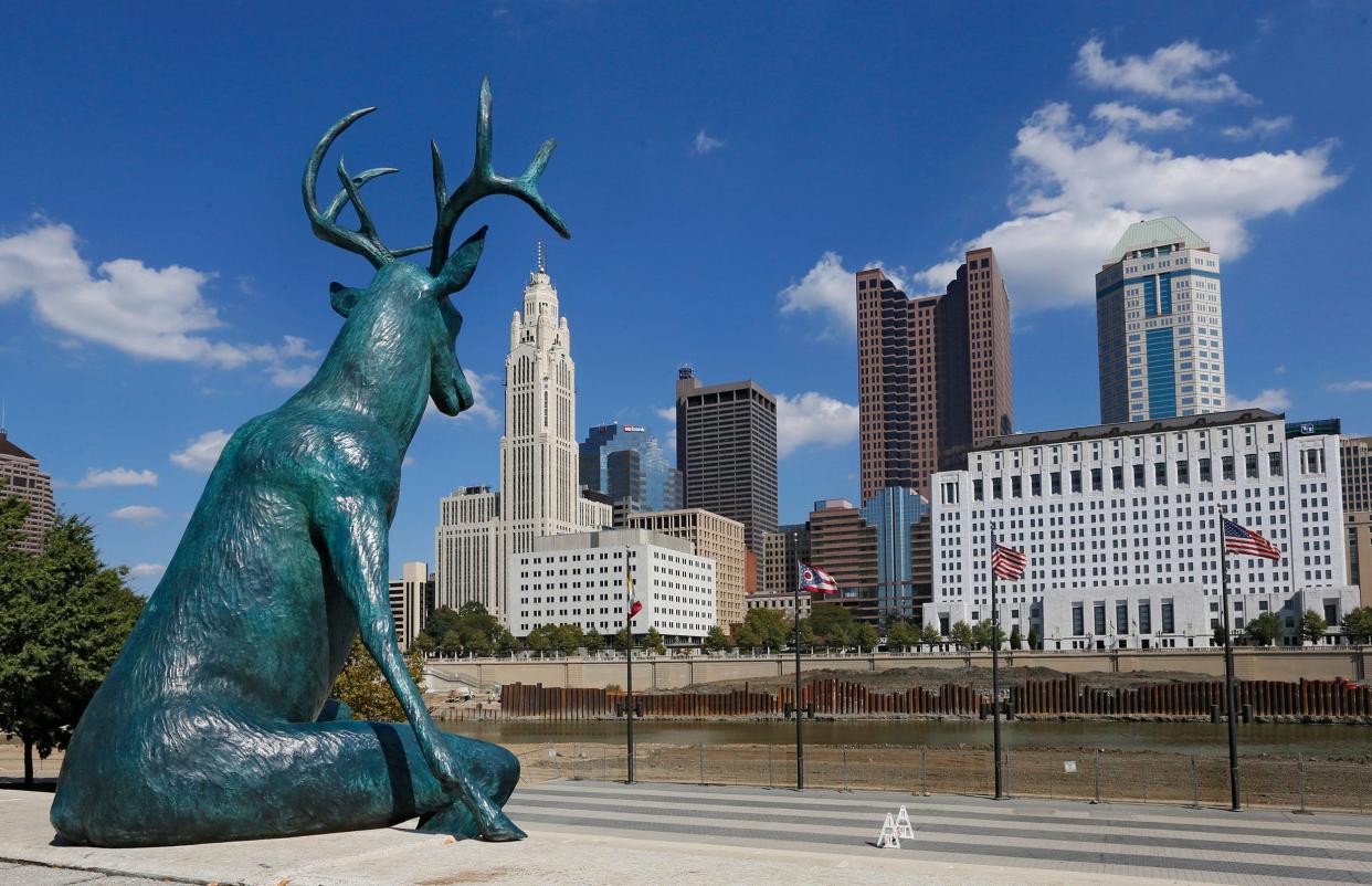 Artist Terry Allen, of Sante Fe, New Mexico, created three whimsical, humanized bronze deer statues like this one of a seated buck in Genoa Park in Franklinton overlooking the downtown Columbus skyline and the Scioto River." His artworks are a nod to the river's name, which comes from the Wyandot word for deer, which were extremely plentiful for Native Americans and Ohio Country's "Buckskin Men."