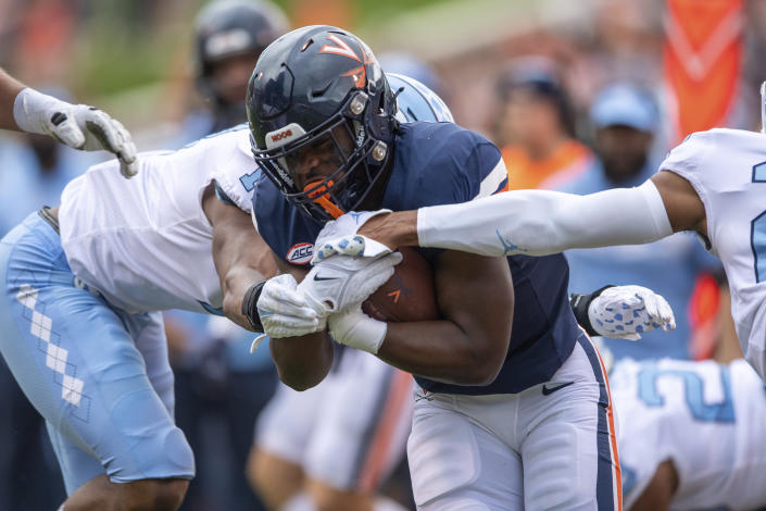 Virginia running back Mike Hollins (7) runs up the middle for a gain against North Carolina during the first half of an NCAA college football game on Saturday, Nov. 5, 2022, in Charlottesville, Va. (AP Photo/Mike Caudill)