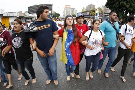 Anti-government protesters march barefooted during a protest in Caracas April 16, 2014. REUTERS/Christian Veron