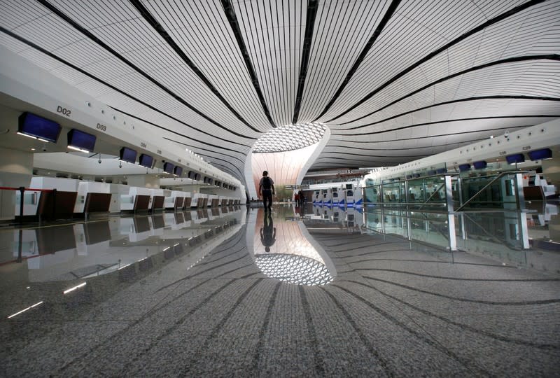 Man walks at the terminal hall of the newly launched Daxing International Airport on the outskirts of Beijing