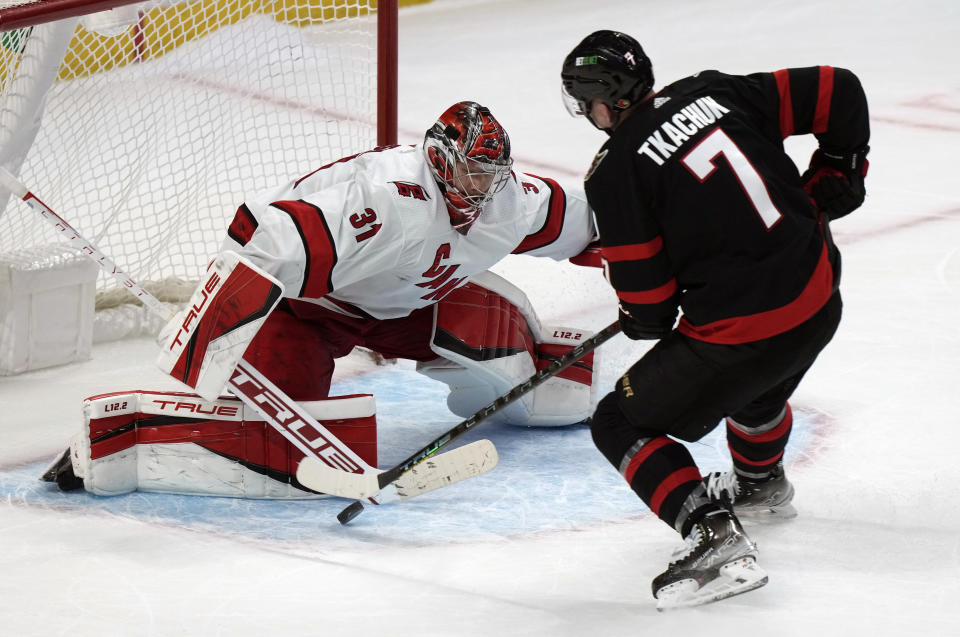 Carolina Hurricanes goaltender Frederik Andersen stops Ottawa Senators left wing Brady Tkachuk as he tries to score during the shootout in an NHL hockey game, Thursday, Jan. 27, 2022 in Ottawa, Ontario. (Adrian Wyld/The Canadian Press via AP)