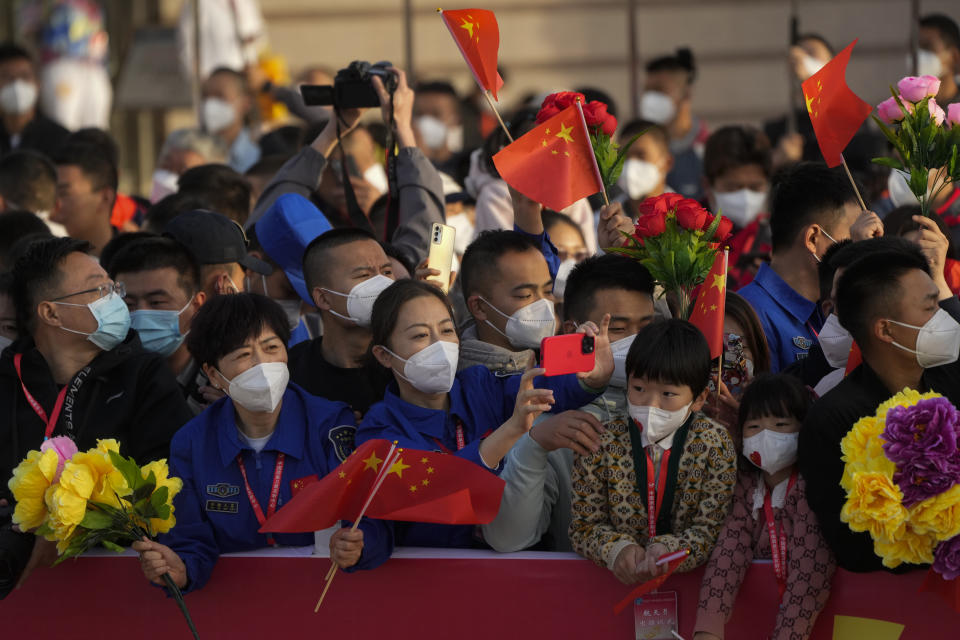 Spectators cheer as Chinese astronauts prepare to board for liftoff for their Shenzhou-16 manned space mission at the Jiuquan Satellite Launch Center in northwestern China, Tuesday, May 30, 2023. (AP Photo/Mark Schiefelbein)