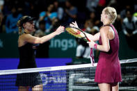 Tennis - WTA Tour Finals - Singapore Indoor Stadium, Kallang, Singapore - October 22, 2018 Kiki Bertens of the Netherlands and Germany's Angelique Kerber shake hands after their group stage match REUTERS/Edgar Su