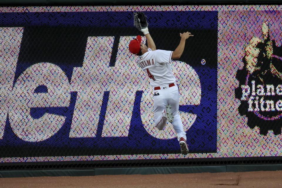 Cincinnati Reds' Shogo Akiyama (4) leaps to grab a ball hit by Detroit Tigers' Harold Castro (30) in the eighth inning during a baseball game against the Detroit Tigers at Great American Ballpark in Cincinnati, Friday, July 24, 2020. The Reds won 7-1. (AP Photo/Aaron Doster)