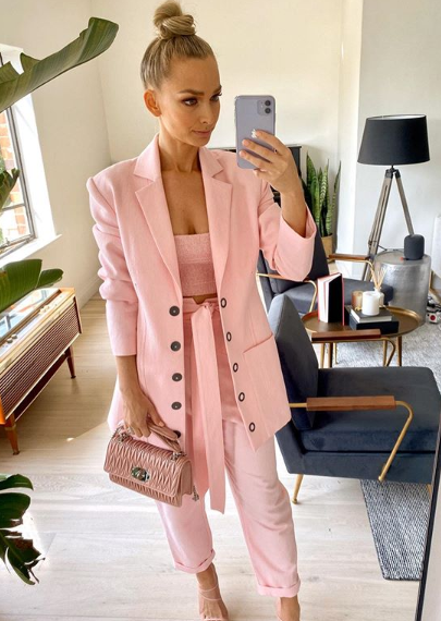 A photo of Anna Heinrich wearing a pink suit.