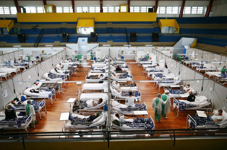 <span class="caption">A COVID-19 field hospital in Santo Andre, Brazil. The pandemic has killed over 503,000 people in Brazil; just 11% of the population is fully vaccinated. </span> <span class="attribution"><a class="link " href="https://www.gettyimages.com/detail/news-photo/health-care-workers-care-for-covid-19-patients-at-a-field-news-photo/1318545805?adppopup=true" rel="nofollow noopener" target="_blank" data-ylk="slk:Mario Tama/Getty Images;elm:context_link;itc:0;sec:content-canvas">Mario Tama/Getty Images</a></span>