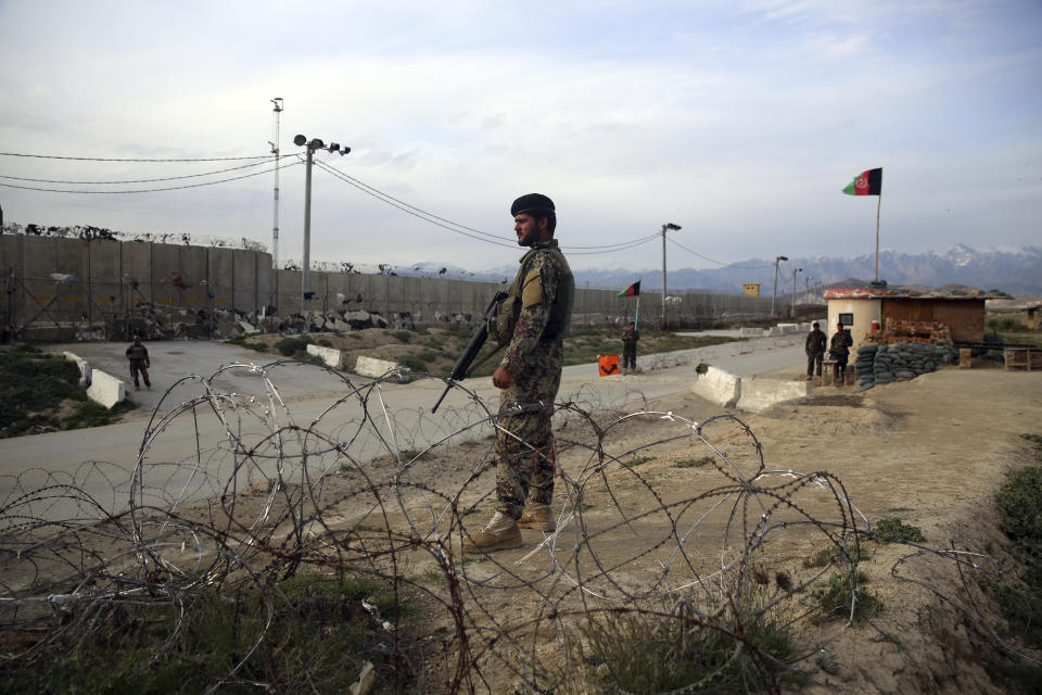 Afghan National Army soldiers stands guard at a checkpoint near the Bagram base in northern Kabul, Afghanistan, Wednesday, April 8, 2020. An Afghan official says the country has released 100 Taliban prisoners from Bagram, claiming they are part of 5,000 detainees who are to be freed under a deal between insurgents and U.S. But the Taliban says they have yet to verify those released were on the list they had handed over to Washington during negotiations. (AP Photo/Rahmat Gul)