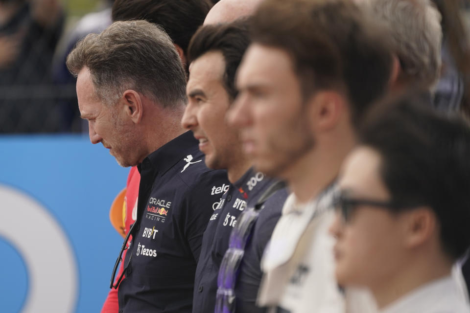 Red Bull team principal Christian Horner, left, pauses during the national anthem before the Formula One U.S. Grand Prix auto race at Circuit of the Americas, Sunday, Oct. 23, 2022, in Austin, Texas. (AP Photo/Darron Cummings)