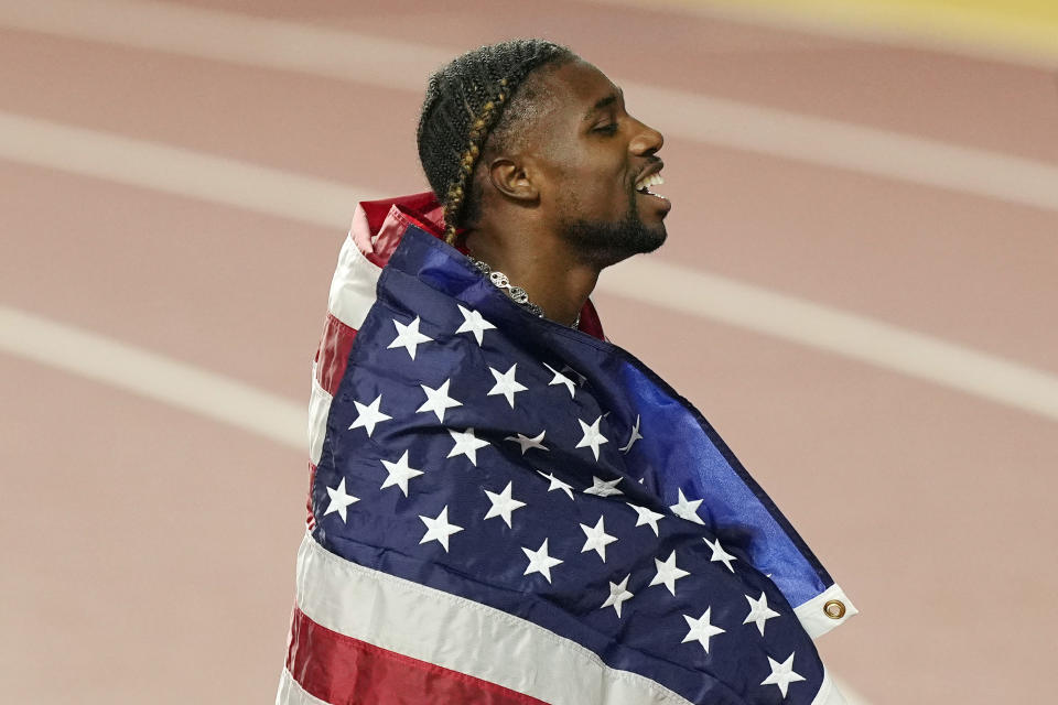 Noah Lyles, of the United States celebrates after winning the gold medal in the Men's 200-meters final during the World Athletics Championships in Budapest, Hungary, Friday, Aug. 25, 2023. (AP Photo/Martin Meissner)